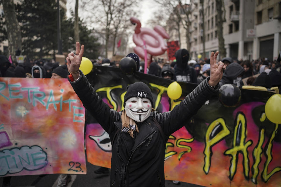 People demonstrate in Lyon, central France, Tuesday, March 7, 2023. Demonstrators were marching across France on Tuesday in a new round of protests and strikes against the government's plan to raise the retirement age to 64, in what unions hope to be their biggest show of force against the proposal. (AP Photo/Laurent Cipriani)