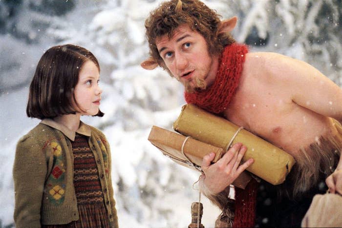 Lucy and Mr. Tumnus from The Chronicles of Narnia conversing, with winter backdrop and Mr. Tumnus holding parcels