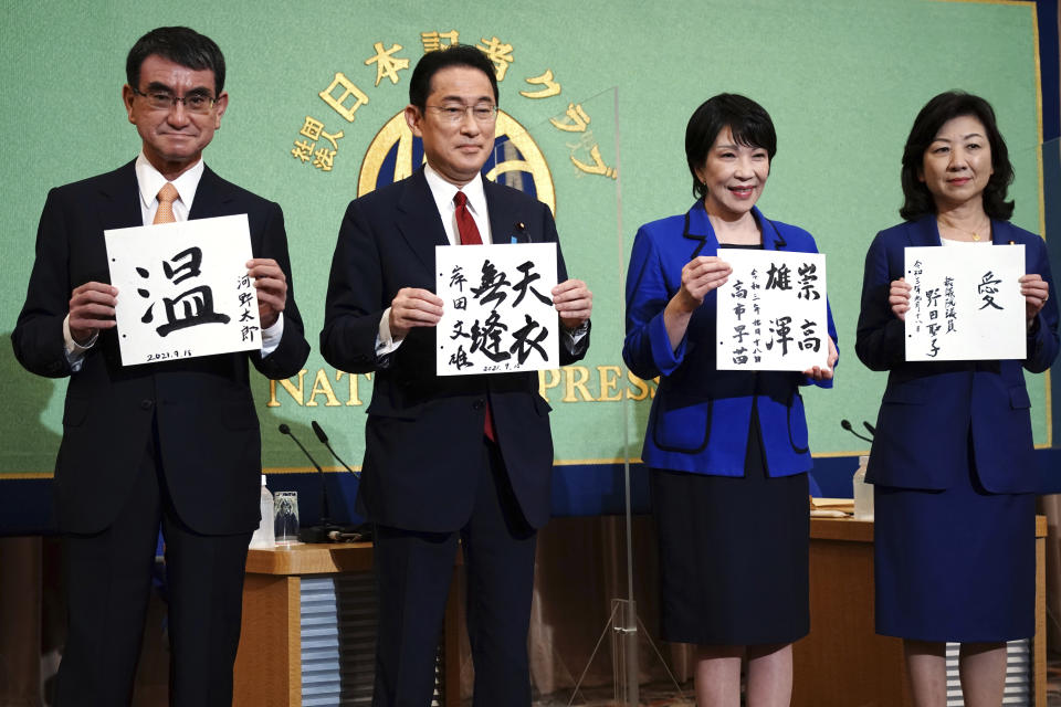 Candidates for the presidential election of the ruling Liberal Democratic Party pose with paper with their sign and words prior to debate session held by Japan National Press club Saturday, Sept. 18, 2021 in Tokyo. The contenders are from left, Taro Kono, the cabinet minister in charge of vaccinations, Fumio Kishida, former foreign minister, Sanae Takaichi, former internal affairs minister, and Seiko Noda, former internal affairs minister. (AP Photo/Eugene Hoshiko, Pool)