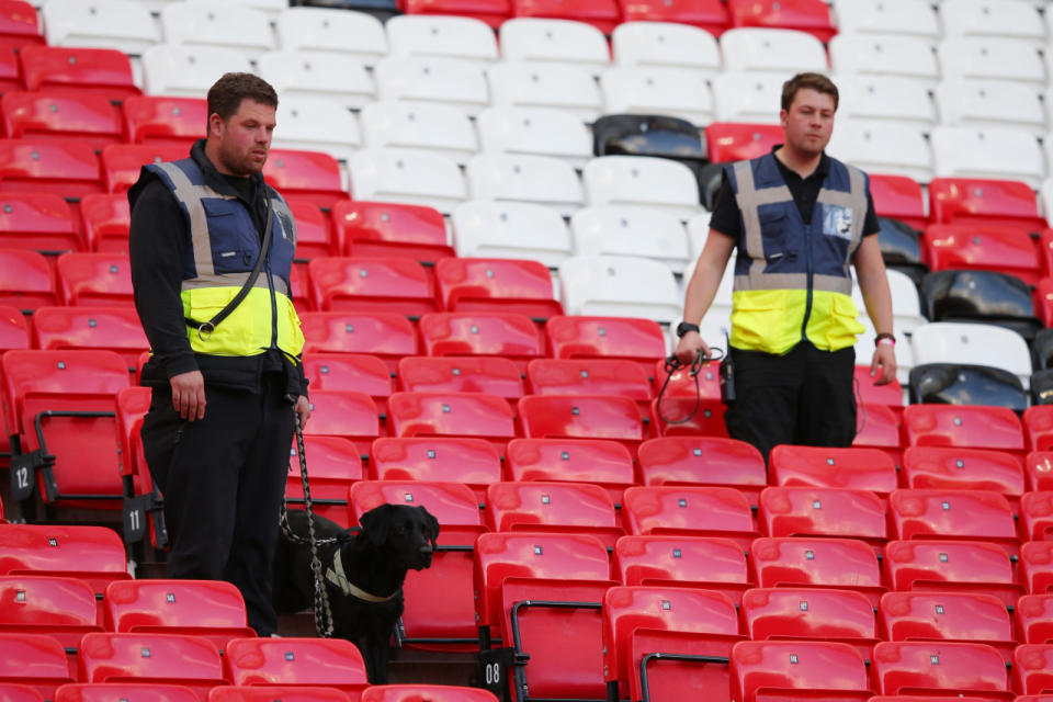 A sniffer dog patrols the stands after fans were evacuated prior to the Barclays Premier League match between Manchester United and AFC Bournemouth at Old Trafford on May 15, 2016, in Manchester, England. (Alex Livesey/Getty Images)