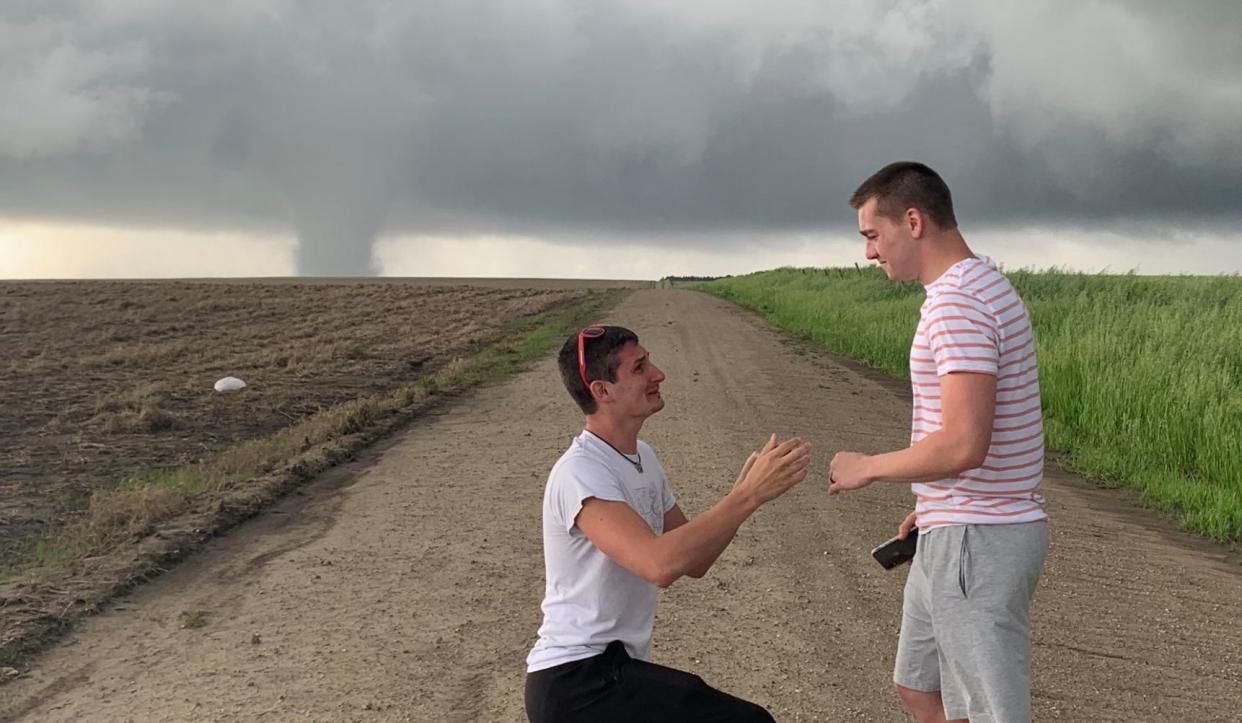 Storm chaser Joey Krastel proposes to his boyfriend as a twister rages in the background. (Photo: Twitter)