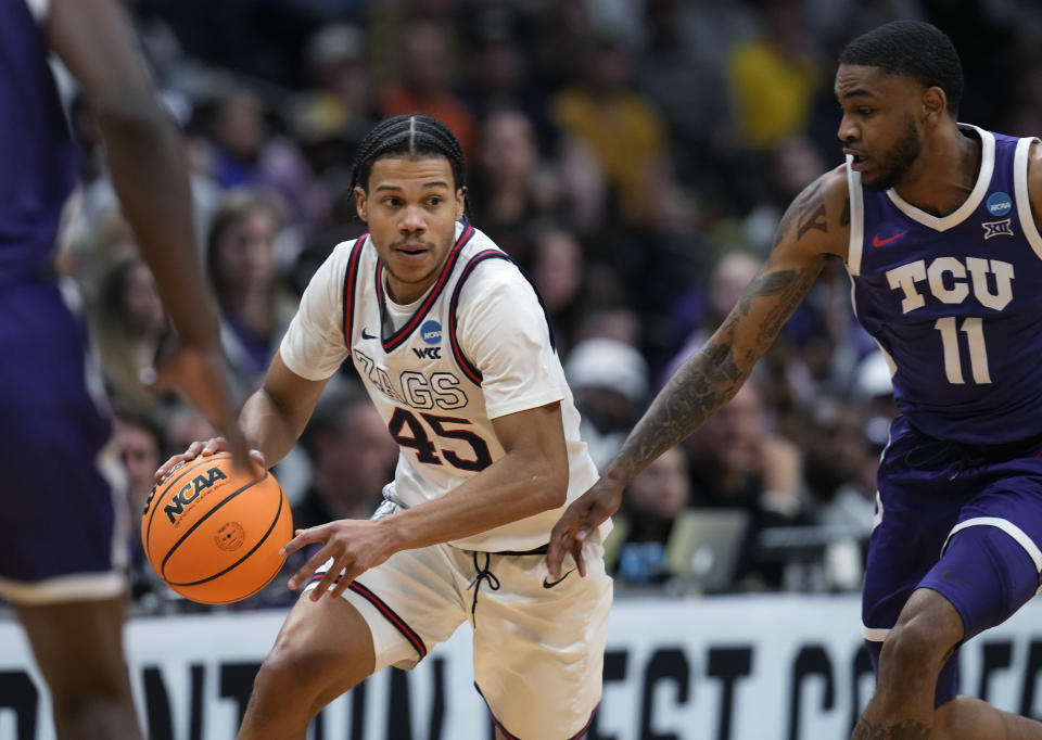 Gonzaga guard Rasir Bolton, left, picks up a loose ball as TCU guard Rondel Walker defends in the second half of a second-round college basketball game in the men's NCAA Tournament Sunday, March 19, 2023, in Denver. (AP Photo/David Zalubowski)