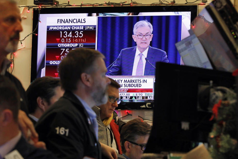 FILE - In this Dec. 11, 2019, file photo a television screen on the floor of the New York Stock Exchange shows Federal Reserve Board Chair Jerome Powell's Washington news conference. The Federal Reserve approved a proposal Thursday, Jan. 30, 2020, to loosen a financial-crisis era rule that prevents banks from investing in venture capital funds. (AP Photo/Richard Drew, File)