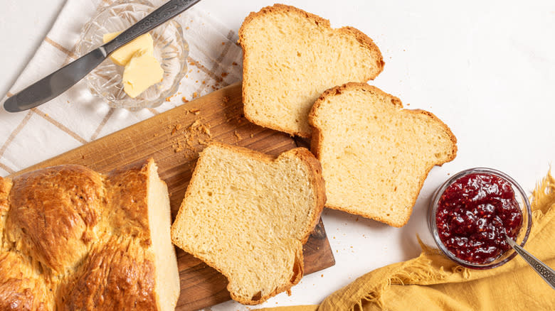 Slices of brioche bread with a side of jam and butter