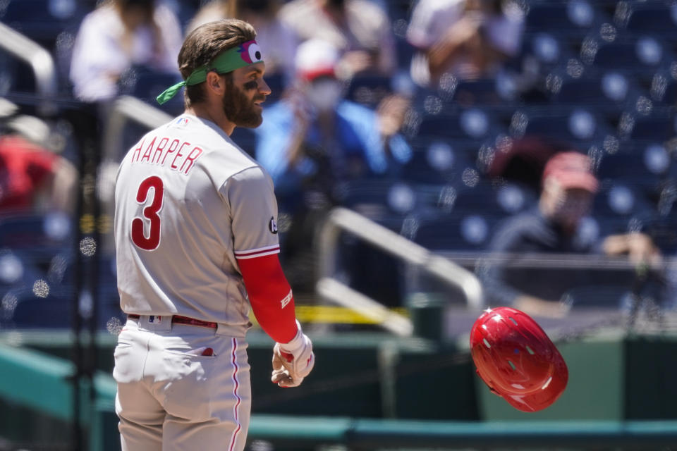 Philadelphia Phillies' Bryce Harper tosses his helmet after striking out during the third inning of a baseball game against the Washington Nationals at Nationals Park, Thursday, May 13, 2021, in Washington. (AP Photo/Alex Brandon)