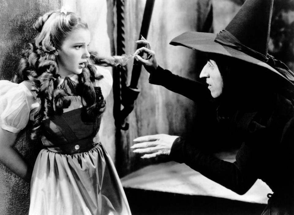 Dorothy, played by Judy Garland, is being threatened by the Wicked Witch of the West, portrayed by Margaret Hamilton, in a scene from "The Wizard of Oz."