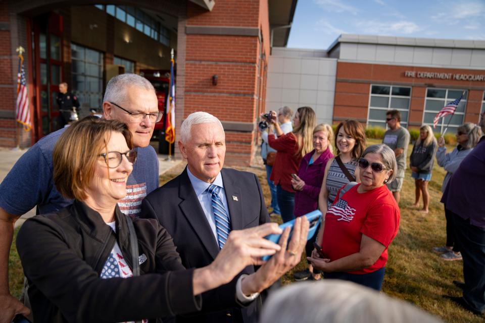 Republican presidential candidate former Vice President Mike Pence takes a picture with Anna and Steve Wittmuss during a 9/11 remembrance ceremony at the Ankeny Fire Department, Monday, Sept. 11, 2023.