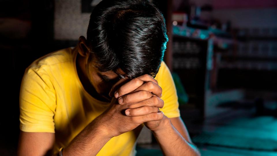 PHOTO: Portrait of disturbed, tensed Indian young man looking down and thinking at home. (STOCK IMAGE/Getty Images)