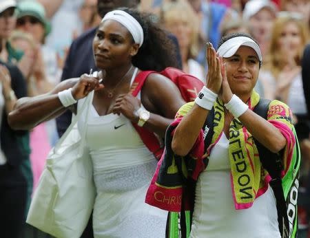 Heather Watson of Britain applauds the fans after losing her match to Serena Williams of the U.S.A. (L) at the Wimbledon Tennis Championships in London, July 3, 2015. REUTERS/Stefan Wermuth