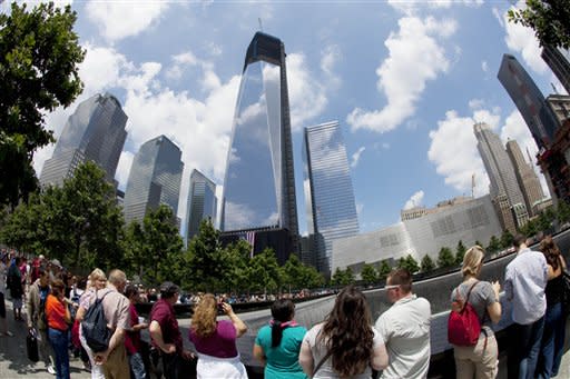 Visitors to the National September 11 Memorial get a view of One World Trade Center, center, Thursday, June 14, 2012 in New York. President Barack Obama is scheduled to visit the site later Thursday. (AP Photo/Mark Lennihan)