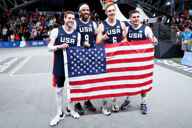 <p>Andy Lyons/Getty</p> Canyon Barry, Dylan Travis, Jimmer Fredette and Kareem Maddox of Team USA after winning the Gold Medal Game of Men's Basketball 3x3 at Estadio Espanol on Day 3 of Santiago 2023 Pan Am Games on October 23, 2023 in Santiago, Chile. (