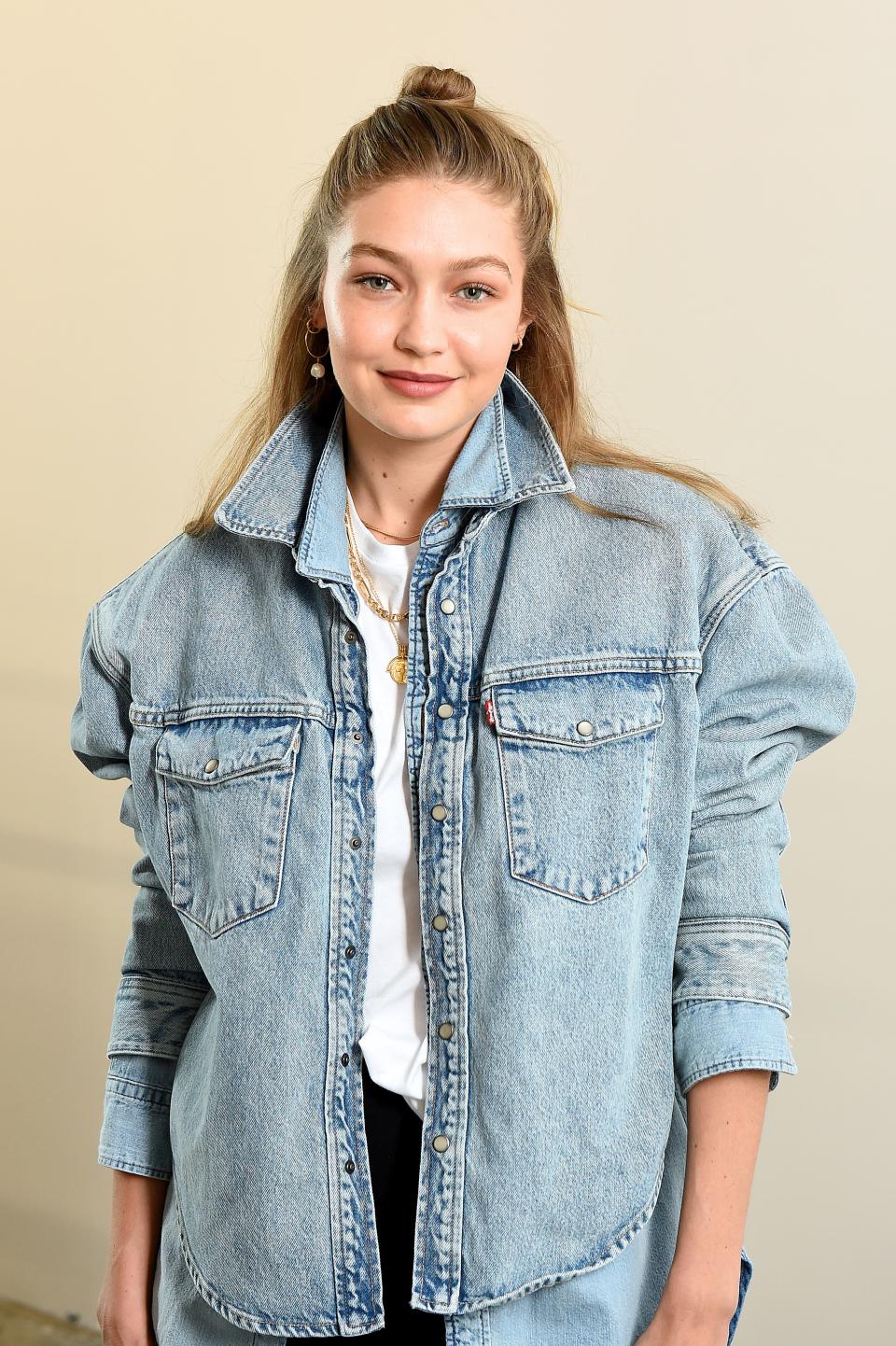 Gigi Hadid looks fantastic in denim jacket and black pant to match as she poses for the camera