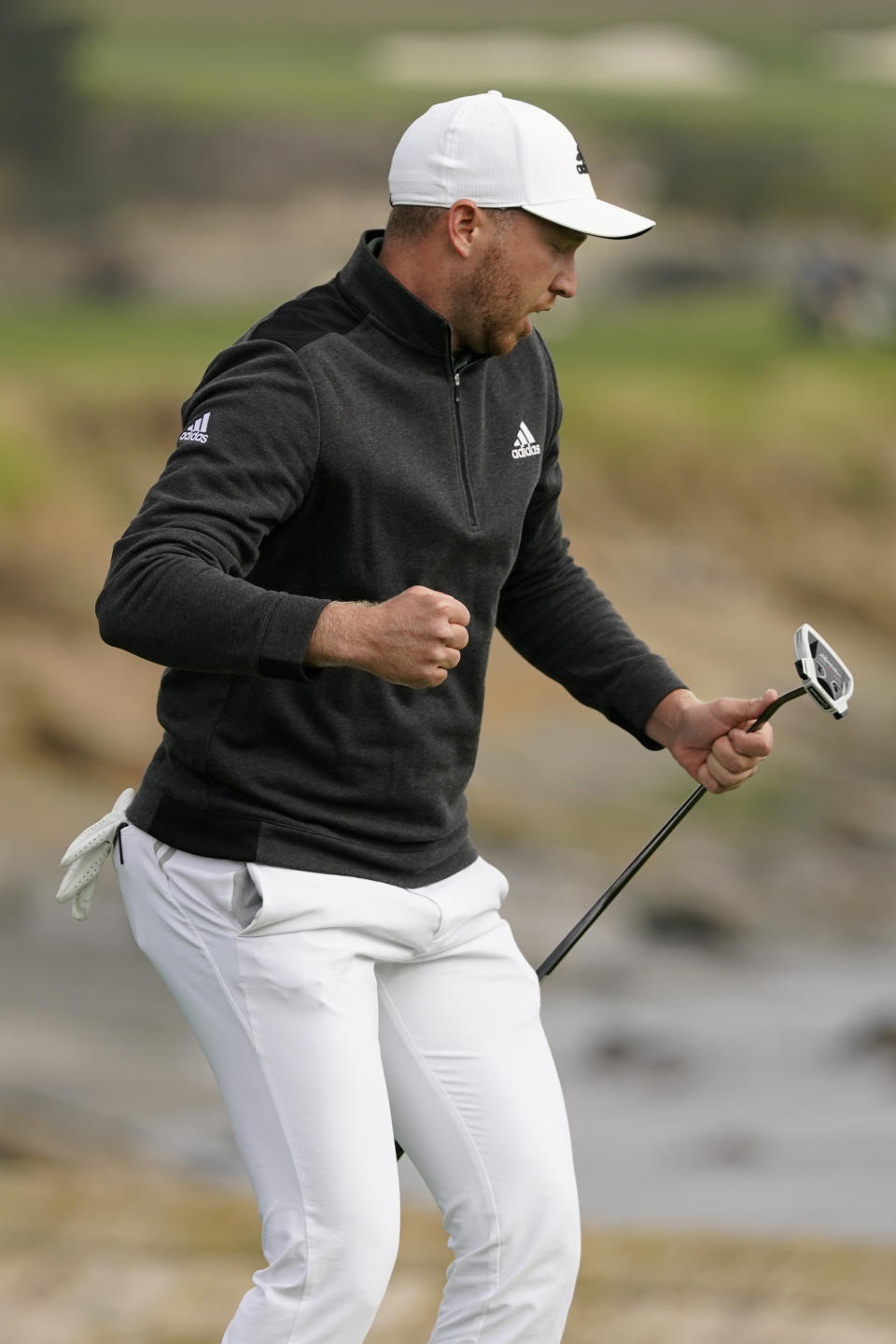 Daniel Berger reacts after making an eagle putt on the 18th green of the Pebble Beach Golf Links during the final round of the AT&T Pebble Beach Pro-Am golf tournament Sunday, Feb. 14, 2021, in Pebble Beach, Calif. Berger won the tournament. (AP Photo/Eric Risberg)