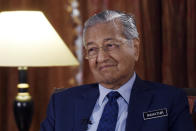 Malaysia's Prime Minister Mahathir Mohamad listens during an interview with The Associated Press in Putrajaya, Malaysia, Monday, Aug. 13, 2018. Mahathir said he will seek to cancel multibillion-dollar Chinese-backed infrastructure projects that were signed by his predecessor as his government works to dig itself out of debt, and he blasted Myanmar’s treatment of its Rohingya minority as "grossly unjust." (AP Photo/Yam G-Jun)
