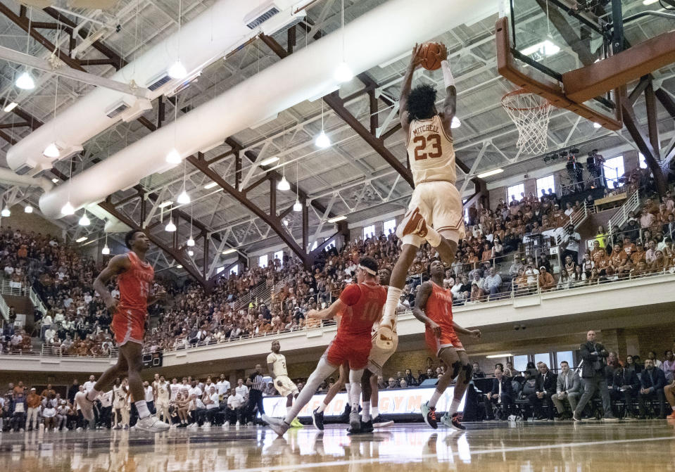 Texas guard Dillon Mitchell (23) goes up for a dunk against Texas Rio Grande Valley forward Dima Zdor (10) during the first half of an NCAA college basketball game, Saturday, Nov. 26, 2022, in Austin, Texas. (AP Photo/Michael Thomas)