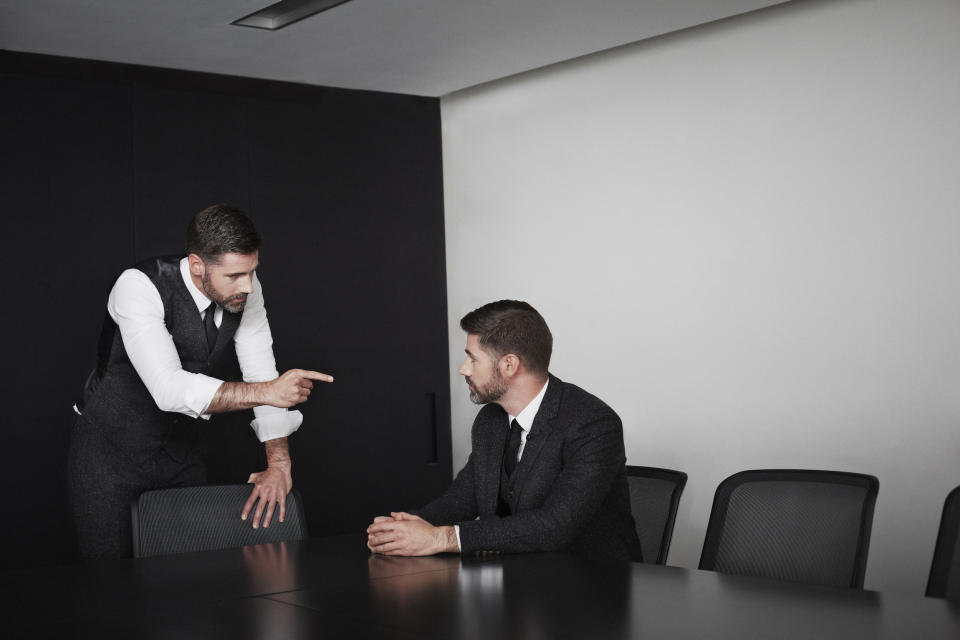 A boss reprimanding an employee