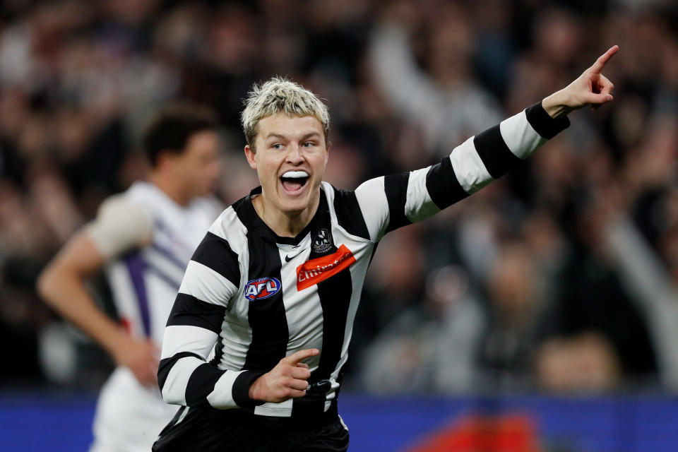 Seen here, Collingwood's Jack Ginnivan celebrates a goal during a 2022 semi-final match against the Fremantle Dockers at the MCG. 