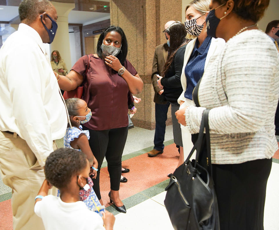 Image: Sharde Butler with her husband, Lance, before a hearing  in Austin on March 30, 2021. (Elizabeth Conley / Houston Chronicle)