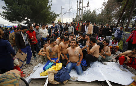 Migrants stage a demonstration in front of Macedonian police, as they wait to cross the border from Greece to Gevgelija, Macedonia November 22, 2015. REUTERS/Ognen Teofilovski