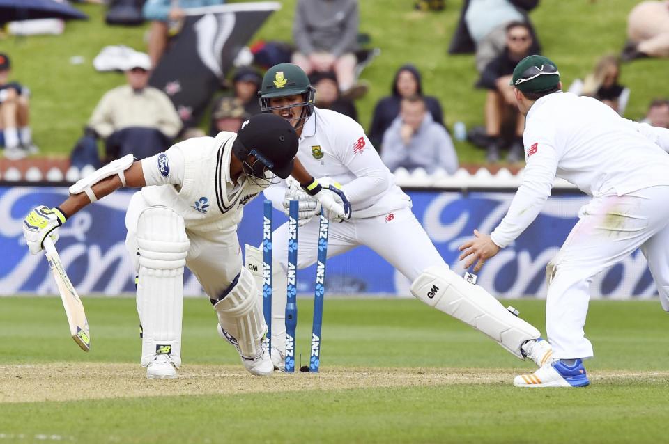 South Africa's Quentin de Kock, center, attempts a stumping on New Zealand's Jeet Raval during the second cricket test at the Basin Reserve in Wellington, New Zealand, Saturday, March 18, 2017. (Ross Setford/SNPA via AP)