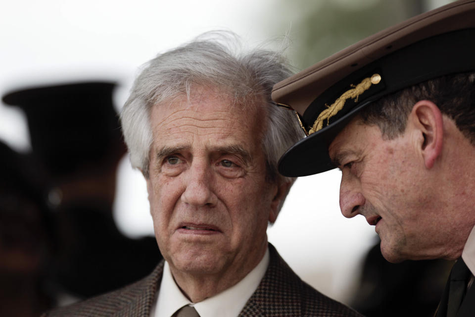 In this Oct. 29, 2018 photo, Uruguay's President Tabare Vazquez, left, listens to his commander-in-chief of the army Guido Manini Rios during a ceremony honoring independence war hero Joaquin Lencinas, also known as "Ansina," in Montevideo, Uruguay. Announced on Tuesday, March 12, 2109, Uruguay’s president has removed Manini Rios after he questioned how local courts have handled cases involving members of the military accused of crimes against humanity committed during the 1973-1985 dictatorship. (AP Photo/Matilde Campodonico)