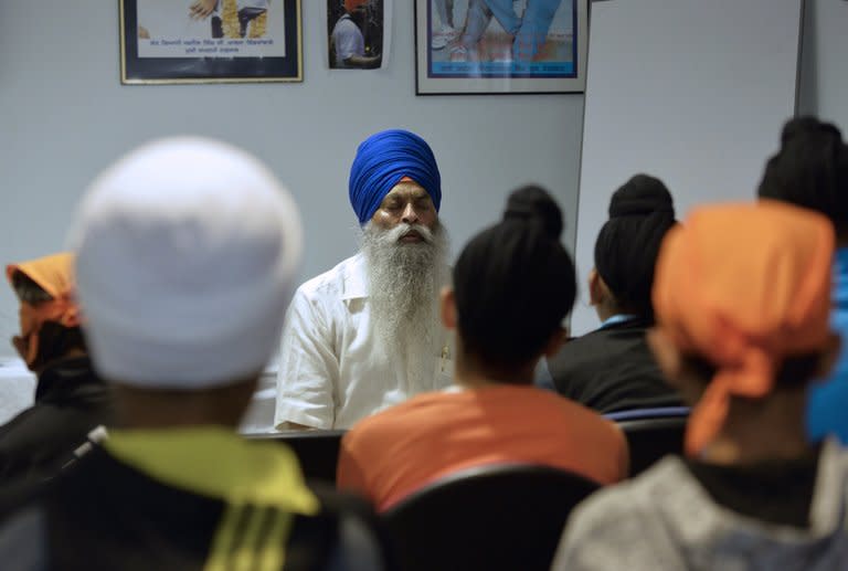 Members of the Sikh community pray on September 22, 2013 at the largest gurdwara or Sikh temple in France, located in the Paris suburb of Bobigny. France's Sikh community is ramping up a campaign for the turban to be allowed in state-funded schools amid moves to reinforce a 2004 law banning pupils from sporting religious symbols