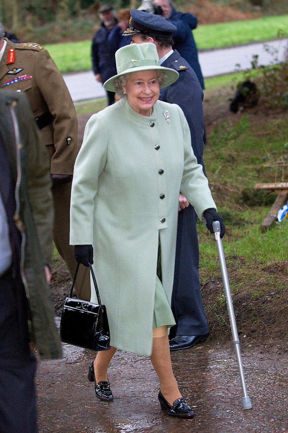 Queen Elizabeth Ll, With Her Knee Bandaged And Using A Walking Stick For Extra Support, Arrives To Open The New Gates At Her Home, Sandringham. The Gates Are A Golden Jubilee Gift From The Armed Forces Of Great Britain.