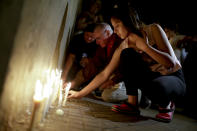 <p>Locals place candles outside the Polytechnic School during a vigil in Rosario, Argentina, Wednesday, Nov. 1, 2017. Five victims killed in the bike path attack near the World Trade Center in New York were part of a group of friends celebrating the 30th anniversary of their graduation from the Polytechnic School of Rosario, Argentina. (Photo: Natacha Pisarenko/AP) </p>