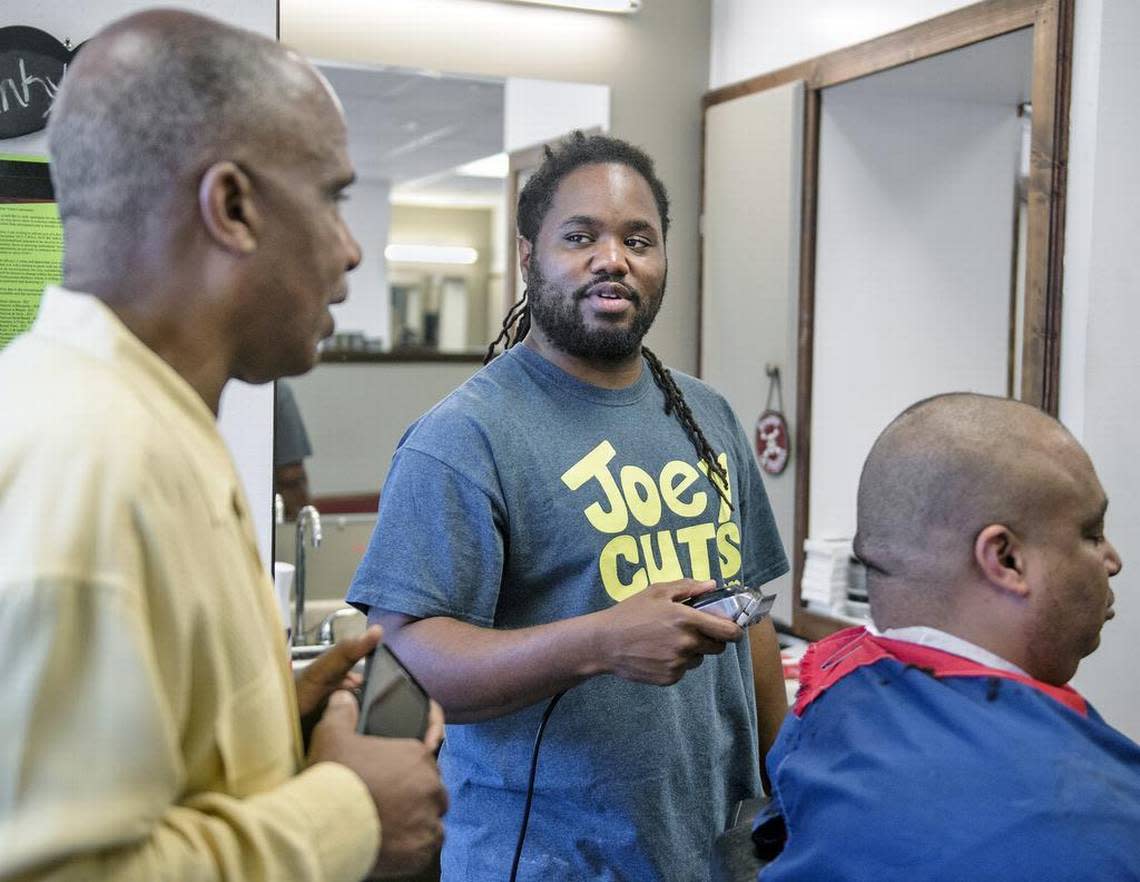 Joseph “Joey Cuts” Thomas, center, a barber at 18th and Vine, organizes an annual Thanksgiving turkey drive.