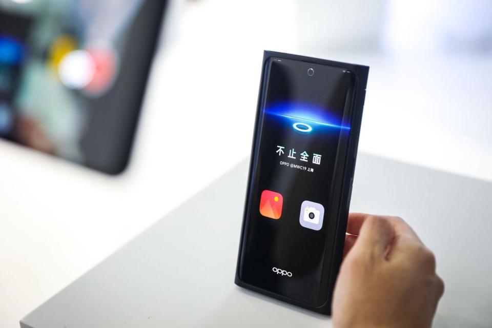 We’ve seen innovative approaches to the selfie camera on smartphones throughout 2019. There’s the notch on the iPhone and Huawei P30 ranges, the slide up on Xiaomi’s Mi Mix 3, the pop-up on the OnePlus 7 Pro and the pinhole on the Samsung S10 devices.Chinese phone maker Oppo, the fifth largest smartphone seller in the world, thinks it has the ultimate way to prevent the selfie camera taking up valuable screen space in the form of an under-screen selfie camera. On display at MWC Shanghai this week, Oppo told the Verge this under-screen camera (USC) is made possible because the display uses a custom transparent material that works with a redesigned pixel structure to allow the light to get through to the camera lens of the phone. The sensor of the camera itself is larger than other selfie lenses out there, with a wider aperture lens in front, in order to be able to still capture images like a normal lens. The issue though is that putting a screen in front of a camera will affect the quality of the images yet luckily we’ve come far enough in camera software technology to be able to overcome this. Oppo says it is developing algorithms that will address these problems to ensure the quality of images taken on the USC is the same as those on standard devices.> The algorithms behind our USC technology showcased at MWC19 include haze removal, HDR and white balance resulting in a bezel-less phone, yet with a selfie camera that rivals current smartphones in the market today. MoreThanTheSeen pic.twitter.com/yTpWgIMLmA> > — OPPO (@oppo) > > June 26, 2019As well as revolutionising the selfie camera, Oppo says that this type of tech will lead to a higher quality, unified smartphone body, which is lighter than other devices, and will be “pleasurable to hold as to see.” Oppo is known for making big bets on new smartphone tech. At MWC in Barcelona earlier this year, the company debuted its 10x lossless zoom camera tech, which is now available on the Oppo Reno 10x Zoom device.Instead of a selfie camera on this phone, it features a slide-up pivot, similar to a shark fin, as an interesting way to house the front camera tech. There’s no word on when Oppo will be launching a device with this type of camera, only saying it will be happening “in the near future”.