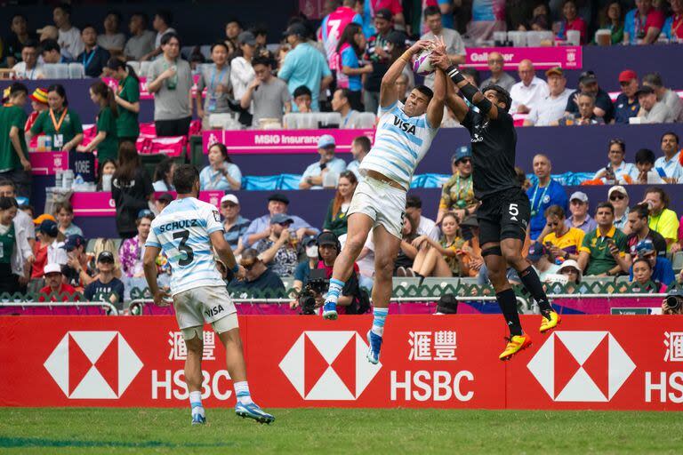 Agustín Fraga, en el aire, ante Dylan Collier, durante el encuentro entre los Pumas y Nueva Zelanda, por el Seven de Hong Kong