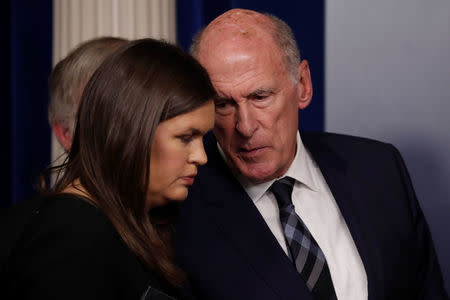 White House Press Secretary Sarah Huckabee Sanders and U.S. Director of National Intelligence Dan Coats talk during a briefing on election security in the White House press briefing room at the White House in Washington, U.S., August 2, 2018. REUTERS/Carlos Barria