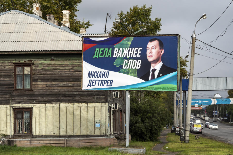 An election poster with a portrait of Mikhail Degtyaryov, a member of the nationalist Liberal Democratic Party and saying "Actions are more important than words," is displayed in the Russian city of Khabarovsk in the country's Far East, Thursday, Sept. 9, 2021. Degtyaryov is on the ballot for governor in the three days of regional voting that concludes Sunday, Sept. 19, 2021. (AP Photo/Igor Volkov)