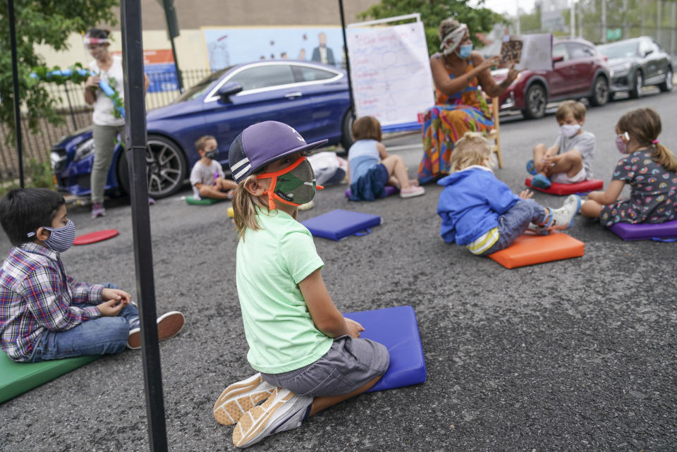 Teachers and students participate in an outdoor learning demonstration to display methods schools can use to continue on-site education during the coronavirus pandemic, Wednesday, Sept. 2, 2020, at P.S. 15 in the Brooklyn borough of New York. (AP Photo/John Minchillo)