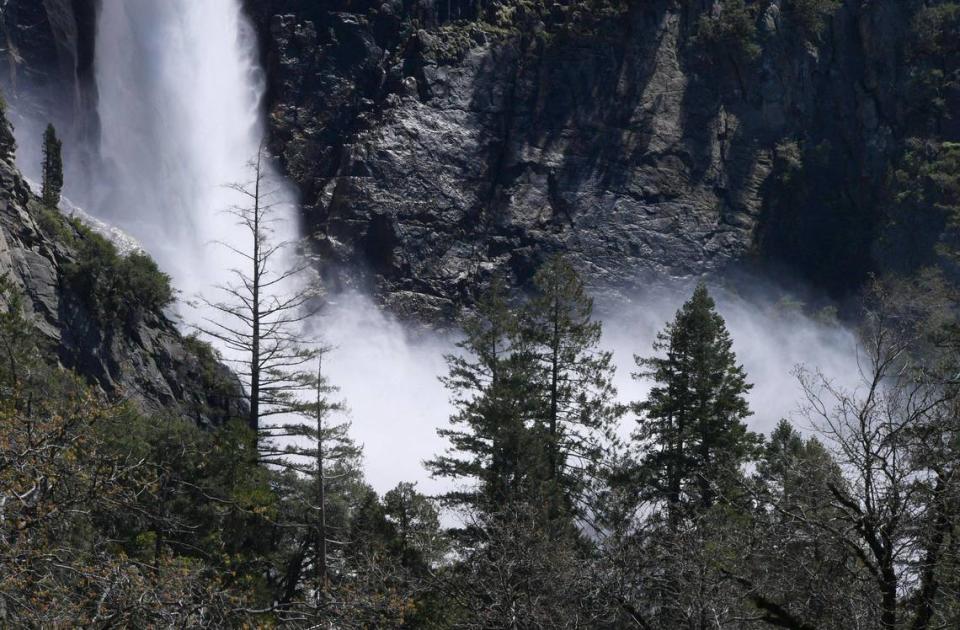 Bridalveil Fall’s mist is seen through the trees Friday, April 28, 2023 in Yosemite Valley. Warmer weather is melting the snow which feeds the waterfalls and rivers.