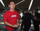 A family member of passengers aboard a missing plane arrives at a reception center at Kuala Lumpur International Airport in Sepang, outside Kuala Lumpur, Malaysia, Saturday, March 8, 2014. A Malaysia Airlines Boeing 777-200 carrying 239 people lost contact over the South China Sea early Saturday morning on a flight from Kuala Lumpur to Beijing, and international aviation authorities still hadn't located the jetliner several hours later. (AP Photo/Lai Seng Sin)