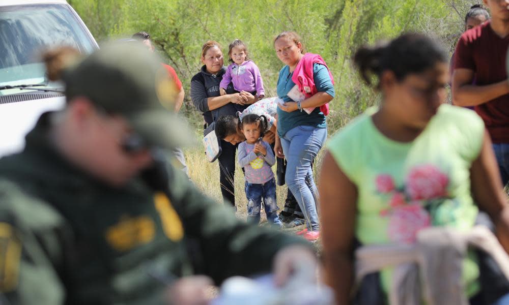 Central American asylum seekers are taken into custody on 12 June 2018 near McAllen, Texas.
