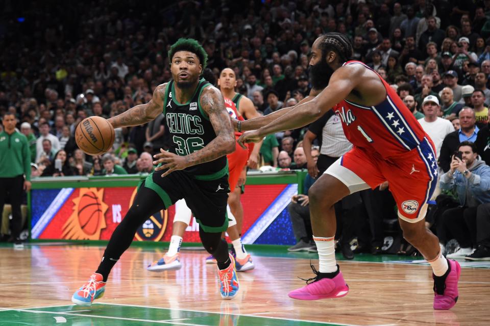 Celtics guard Marcus Smart tries to get around 76ers guard James Harden in the second half of Monday's playoff game. Harden led all players with 45 points.