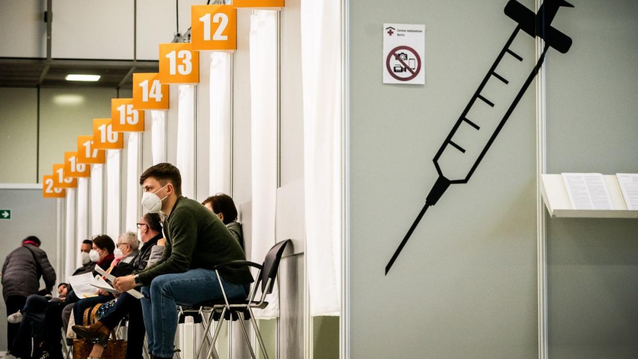 Menschen warten im Corona-Impfzentrum auf dem Messegelände Berlin auf ihre Impfung.