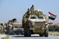 Iraqi government forces drive down a road leading to Tal Afar on June 9, 2017, before the official start of the assault to retake the town from the Islamic State group