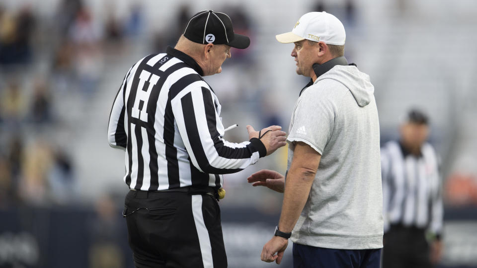 Georgia Tech interim head coach Brent Key speaks with a game official in the first half of an NCAA college football game against Miami, Saturday, Nov. 12, 2022, in Atlanta. (AP Photo/Hakim Wright Sr.)