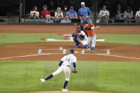 Houston Astros' Alex Bregman (2) hits a two-run triple off Texas Rangers starting pitcher Andrew Heaney (44) during the first inning in Game 4 of the baseball American League Championship Series Thursday, Oct. 19, 2023, in Arlington, Texas. (AP Photo/Tony Gutierrez)