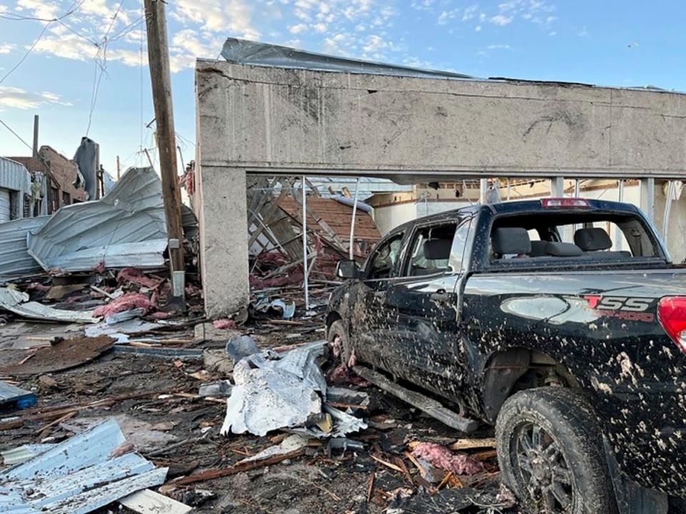 Buildings and a vehicle bear damage from a tornado in Perryton, Texas (Lubbock Avalanche-Journal/AP)