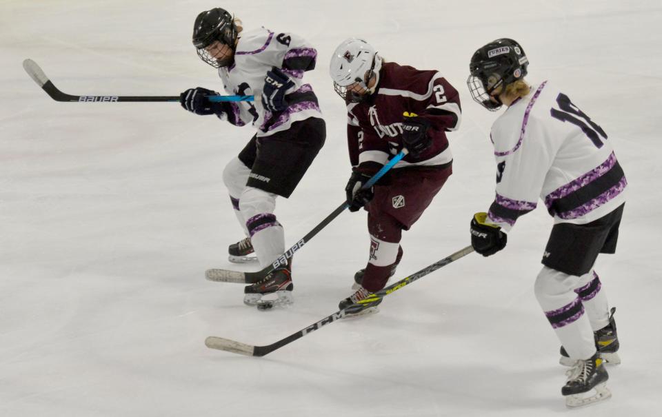 Falmouth's Avery Johnsen, center, tries to block a first period play by Cape Cod Furies' Samantha Clarke, left, and Isabella Roberts.
(Photo: Merrily Cassidy/Cape Cod Times)