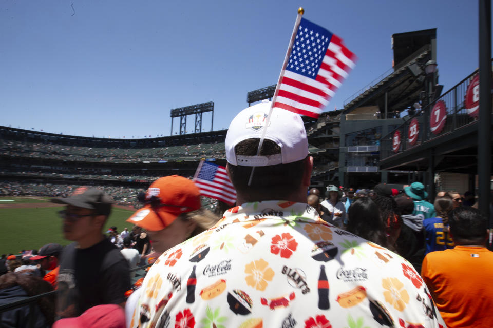 Fans sport patriotic symbols a baseball game between the Seattle Mariners and San Francisco Giants, Tuesday, July 4, 2023, in San Francisco. (AP Photo/D. Ross Cameron)