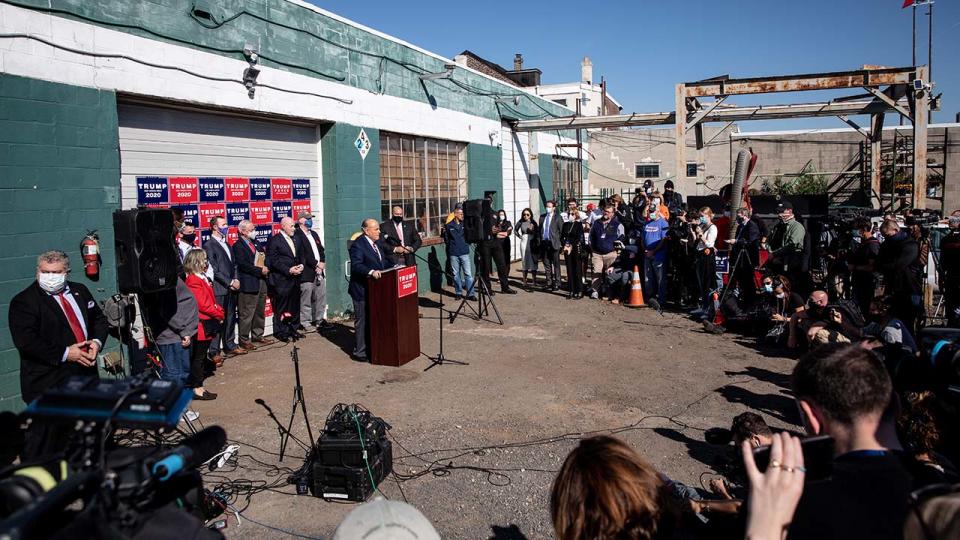 Rudy Giuliani, pictured here speaking to the media at a press conference held in the back parking lot of Four Seasons Total Landscaping.