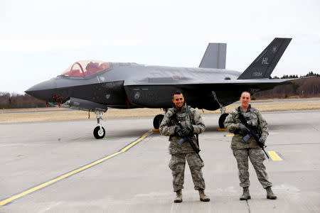 U.S. soldiers guard U.S. Air Force F-35A Lightning II fighter in Amari air base, Estonia, April 25, 2017. REUTERS/Ints Kalnins