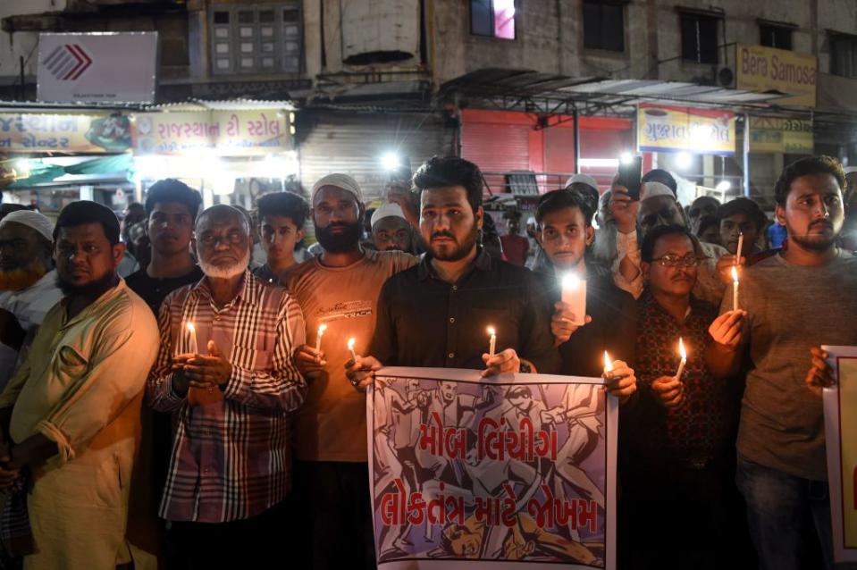 Indian Muslims holding candles and posters as they participate in a protest against the mob lynching of Tabrez Ansari in the Jharkhand state, in Ahmedabad on June 27, 2019.<span class="copyright">SAM PANTHAKY/AFP via Getty Images</span>