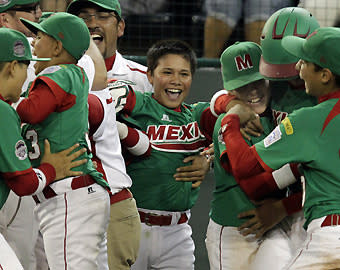 Players and coaches from Mexico celebrate a 3-2 victory over Japan during international pool play on Aug. 21