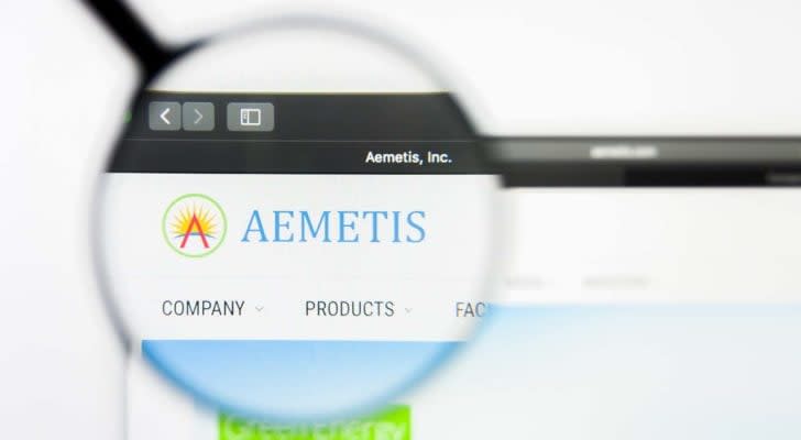 A magnifying glass zooms in on the website for Aemetis (AMTX).